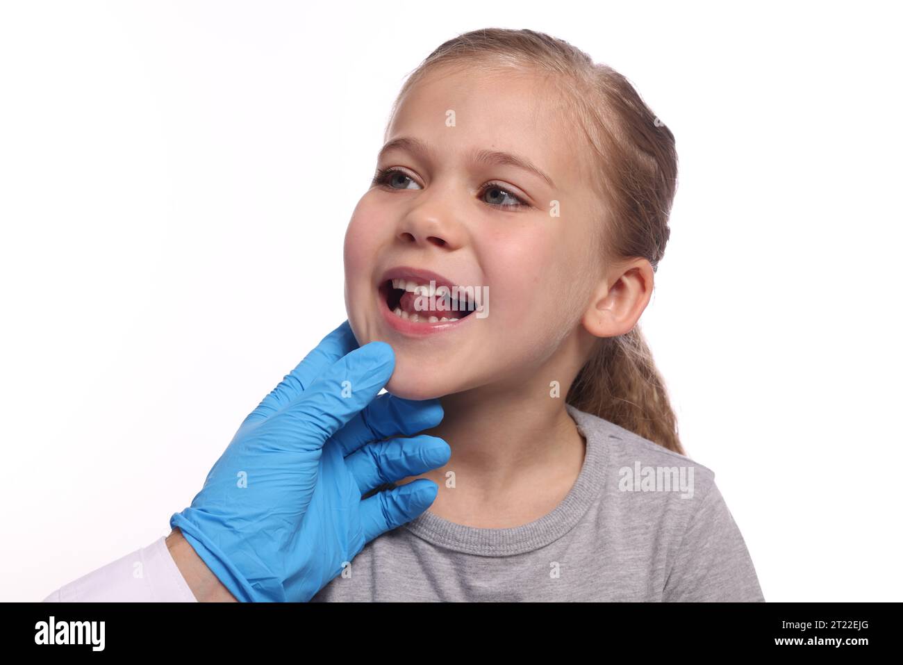 Doctor examining girl`s oral cavity on white background Stock Photo - Alamy